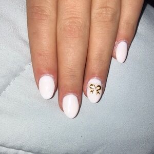Milky white press on nails with a gold bow